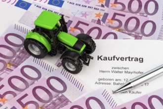 The purchase contract for a new tractor. With euro money and biros
