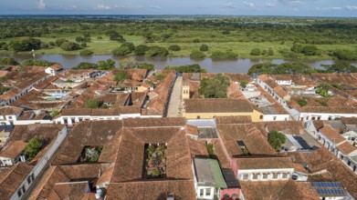 Aerial view of the historic town Santa Cruz de Mompox in sunlight with river and green