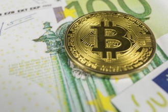 Macro photo of crypto currency concept, A bitcoin with euro bills
