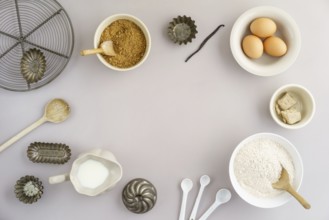 Collection of ingredients and for baking on a light background with text space in the centre