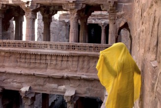 Man with yellow cloth standing at old stepwell tapi baori, Jodhpur, Rajasthan, India, Asia