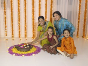Woman lighting oil lamp with her family MR#779P, MR#779Q, MR#779R, MR#779S