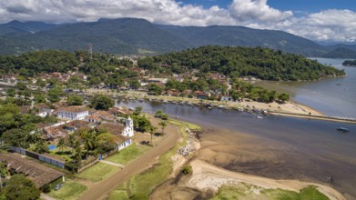 Aerial view to historic town Paraty, tidal river and Jabaquara with green mountains in background