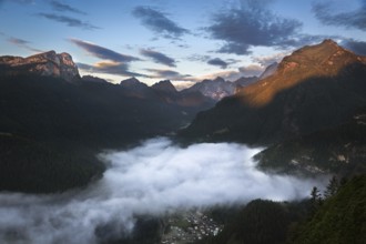 Valley in Dolomites with early morning clouds, Alps, Italy, Europe