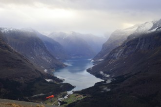 Rays of sunshine shine into Lake Lovatnet near Loen in Norway
