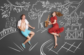 Love story concept of a romantic couple against chalk drawings background. Woman playing serenade