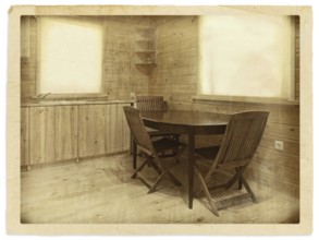 Old (stylized) photo of kitchen interior in a wooden blockhouse