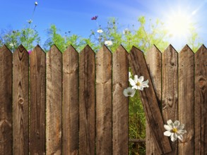 Wooden fence over the courtyard with sky and sun