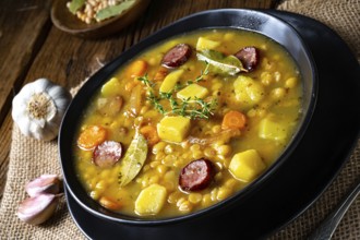 Rustic pea soup with bacon and sausage