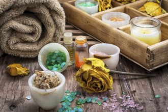 Sea aromatic salt for Spa treatments on the background of yellow rose buds