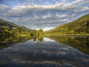 Evening light, forest landscape and clouds reflected in the lake, Gaishorner See, near Gaishorn am