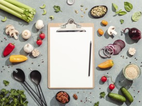 Food ingredients, salad serving utensils and clipboard with white paper sheet. Various of