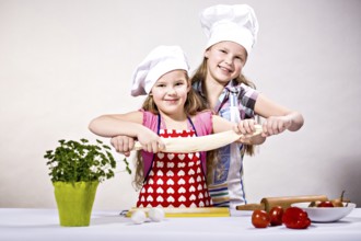 Young girls baking cakes in the kitchen