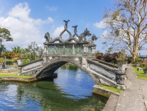 View of bridge in park in Tirta Gangga temple at sunny day in Bali, Indonesia, Asia