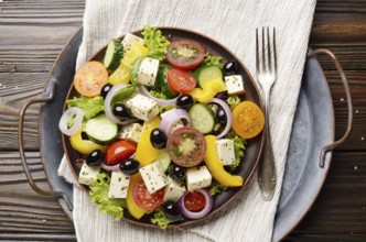 Top view at Mediterranean diet dish greek salad on vintage metal tray