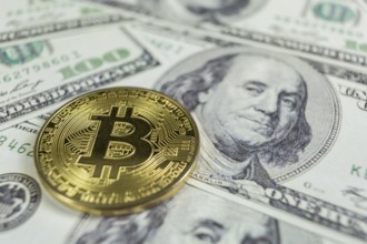 Gold Bitcoin macro photo on hundred dollars bills