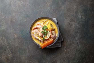 Food, Peruvian seafood soup Chupe de Camarones in gray bowl, top view