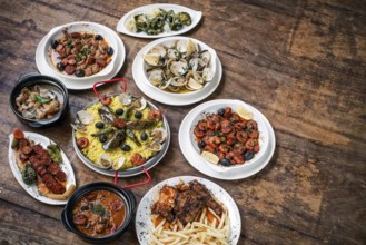 Mixed portuguese traditional rustic tapas famous food selection on wood table