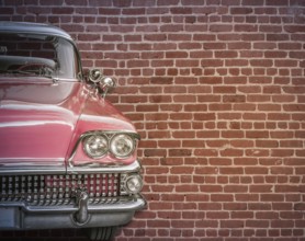 Classic Vintage 50s American Car Against A Red Brick Wall With Copy Spce