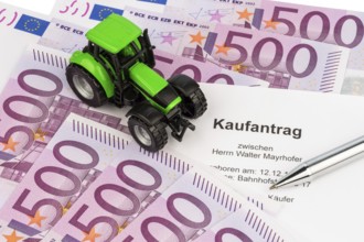 The purchase contract for a new tractor. With euro money and biros