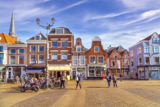 Delft, Netherlands, April 8, 2016: Colorful street view with traditional dutch houses on the
