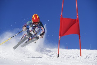 Skiers in action, descent on a slope, deep snow