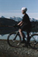 Road bike rider in spring near Halblech in the Allgäu in front of a picturesque backdrop of the