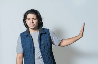 Displeased young man rejecting with palms hands isolated. Upset person making rejection gesture