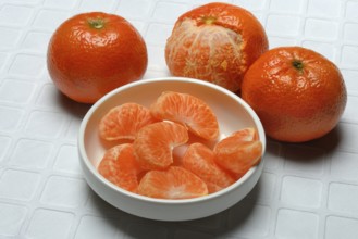 Clementines and clementine pieces in peel, clementine