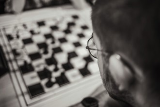 Chess player at the chessboard thinking about his next move, Leoben, Styria, Austria, Europe