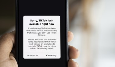 An iPhone screen with the TikTok homepage showing Sorry, TikTok isn't available right now