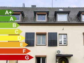 Energy efficiency classes, two solar panels on the façade of an apartment block in Hilden, Germany,