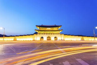 Long exposure car lights curving in front of Gwanghwamun main entrance gate to Gyeongbokgung Palace