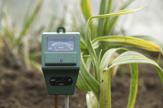 The meter has various indications illustrating its role in monitoring and measuring the moisture