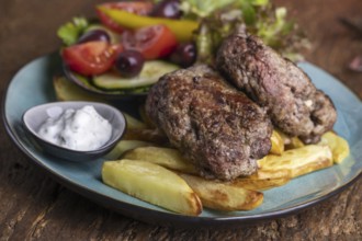 Greek bifteki with salad and chips