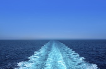 Boat wake ferry cruise wash foam in blue ocean sea