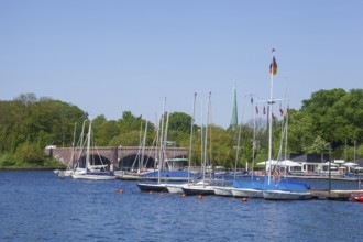 Krugkoppelbrücke with boat hire and Bobby Reich restaurant on the Outer Alster in spring,