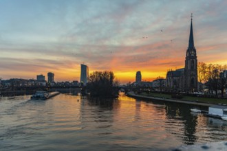 View across the River Main to the ECB and the Protestant Church of the Epiphany. Sunrise in the