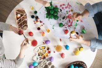 Top view family painting eggs easter