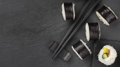 Sushi rolls with chopsticks copy space