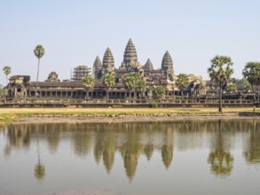 The iconic towers of Angkor Wat and the lake at the west gate, Siem reap, Cambodia, Asia