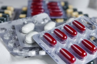Assorted blister packs with red capsules and white pills