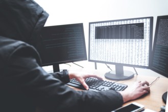 Hack concept. Picture of male hacker trying to steal information from system while looking at