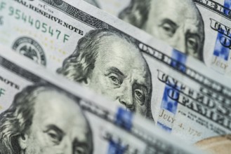 Hundred dollars bills standing in a row. Selective focus