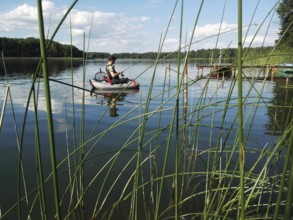 Angler with belly boat on Lake Lübbe