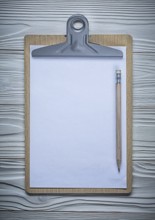 Vertical version clipboard with blanc paper copyspace and pencil on vintage white painted wood