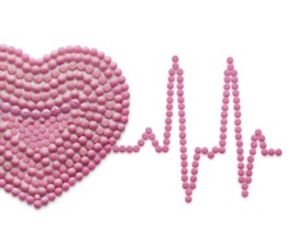 Creative medicine and healthcare concept of drugs and pills, against a white background ECG, a