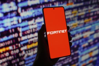 In this photo illustration, the Fortinet logo is displayed on a smartphone screen