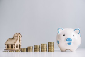 Stack increasing coins piggybank front house model