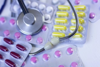 Various medication blister packs and a stethoscope on a table